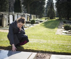 Widow grieving at the cemetery