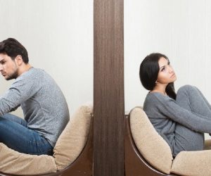 Man and woman sitting and facing the opposite direction