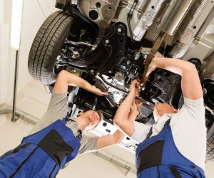 mechanics doing maintenance on car