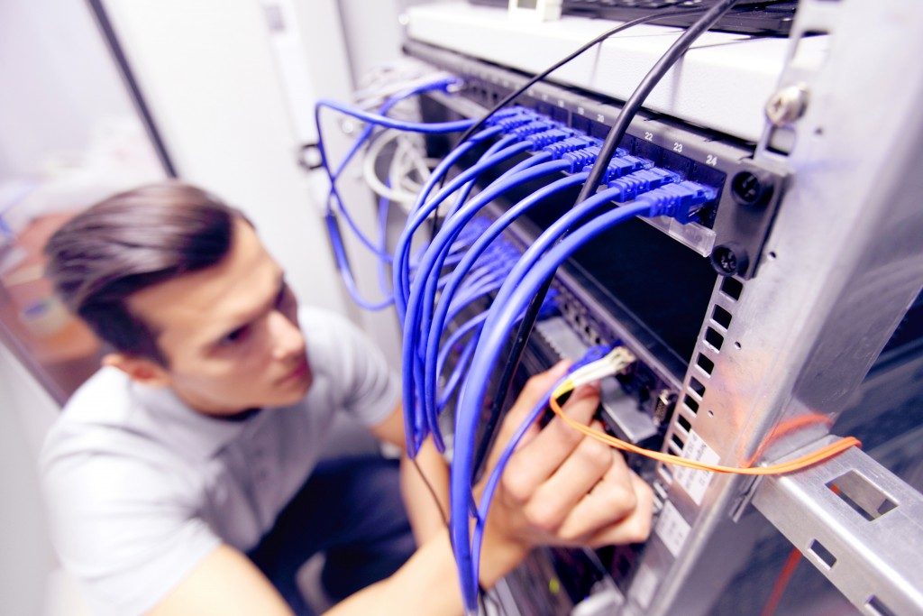Employee fixing the network server room