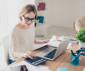 an accountant on her desk balancing a report