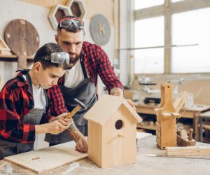 man and son making bird houses