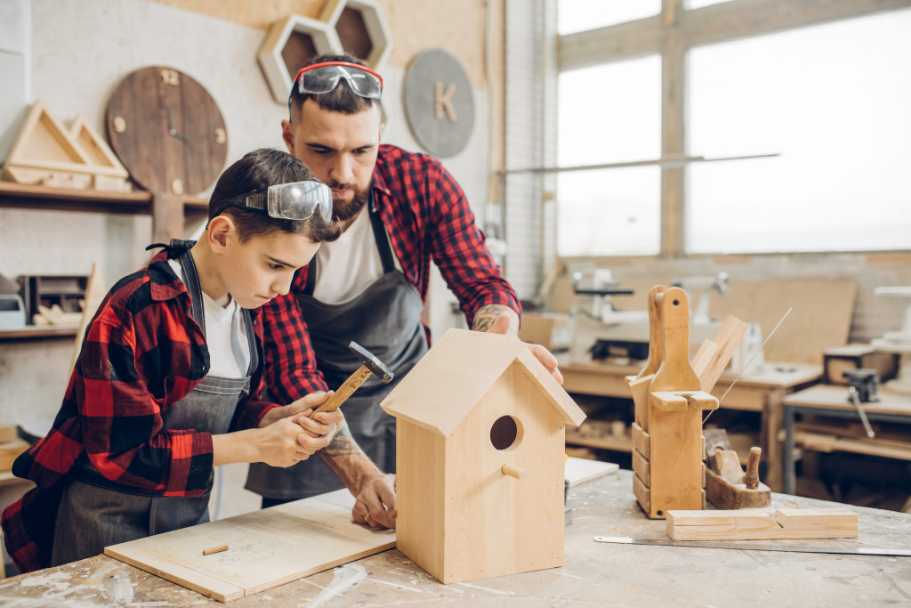 man and son making bird houses