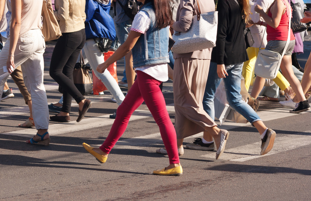 Feet of pedestrians crossing the road