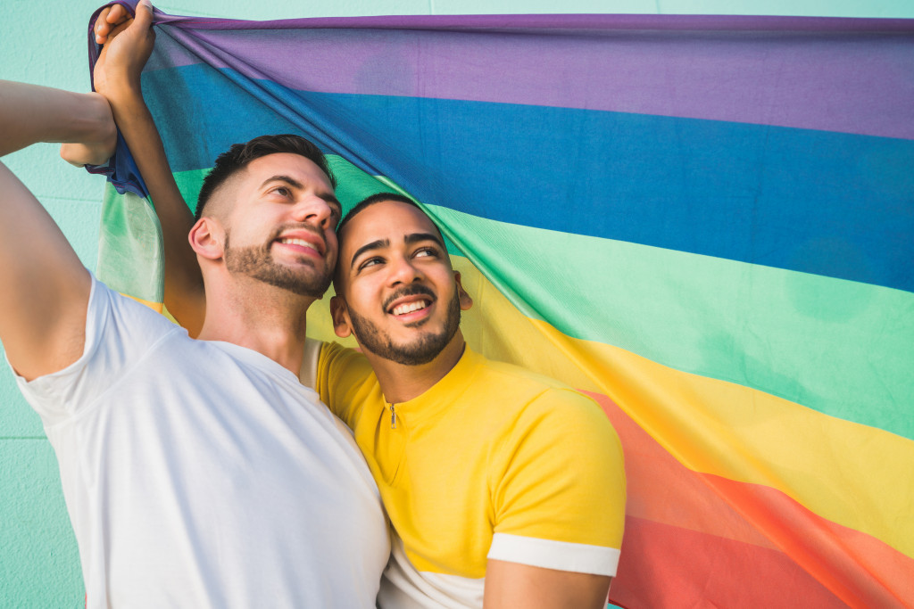 gay couple holding rainbow flag