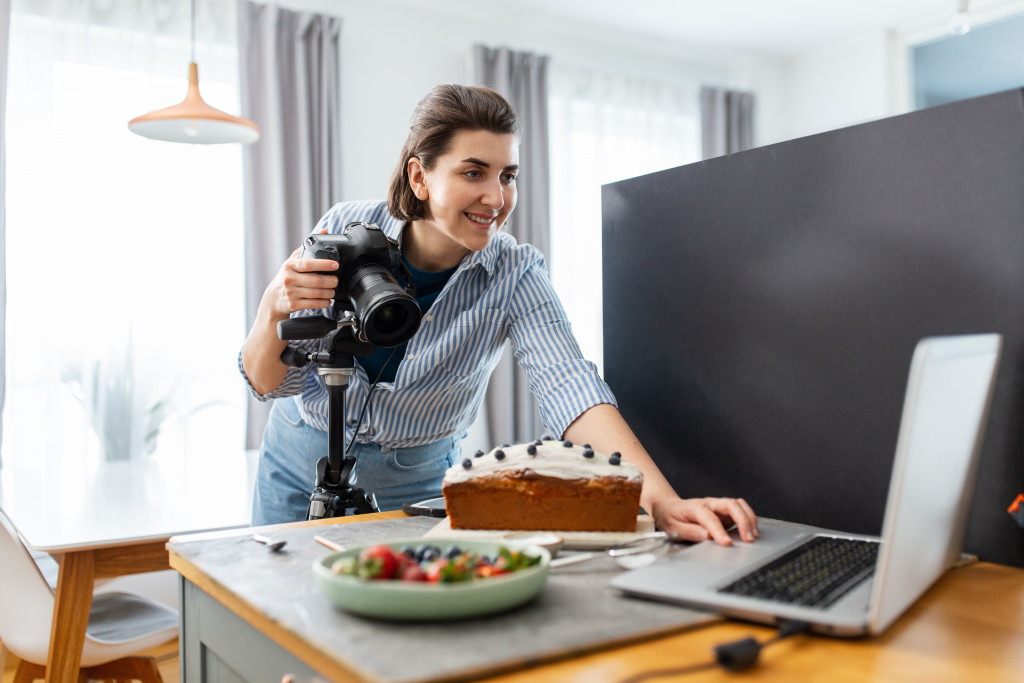 A small business owner preparing to take photos of her cake for online marketing