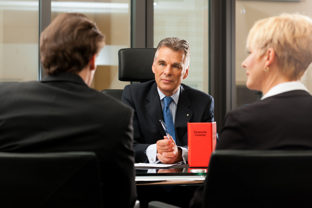 A businessman talking with lawyers